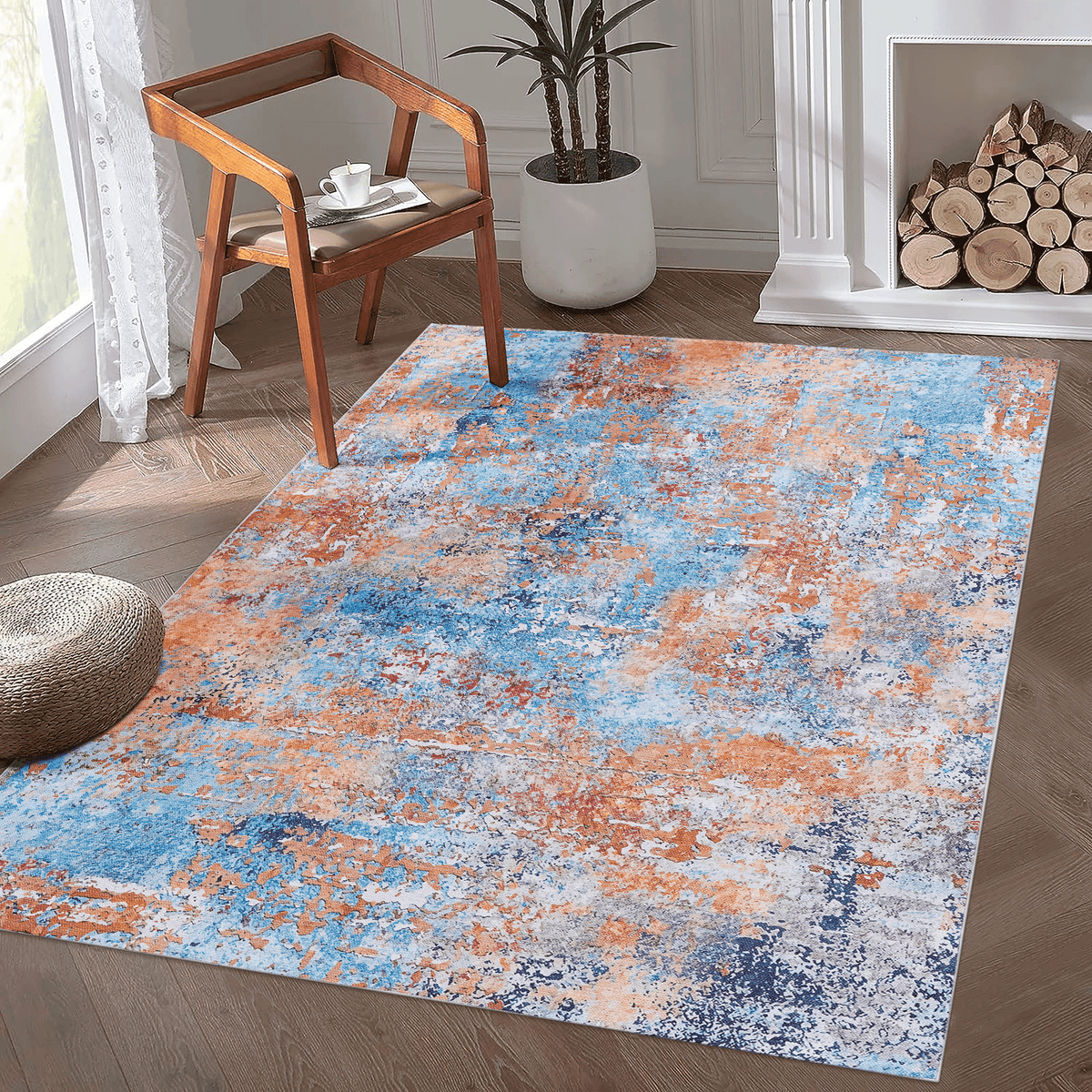 Multi-colored abstract washable area accent rug with blue and orange patterns in a modern living room setting.