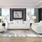 Cozy living room featuring a white sherpa loveseat with a stylish gold base and modern decor.