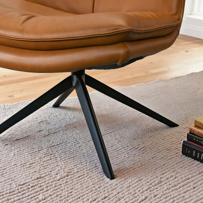 Oakland Cognac Vegan Leather Armless Swivel Chair with X-shape base, showcasing comfort and style.