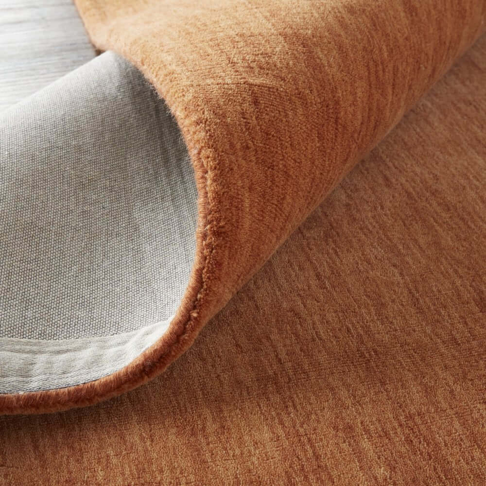Orange Wool Hand Woven Area Rug | 9' x 13' showing textured fabric and backing, highlighting its quality and durability.