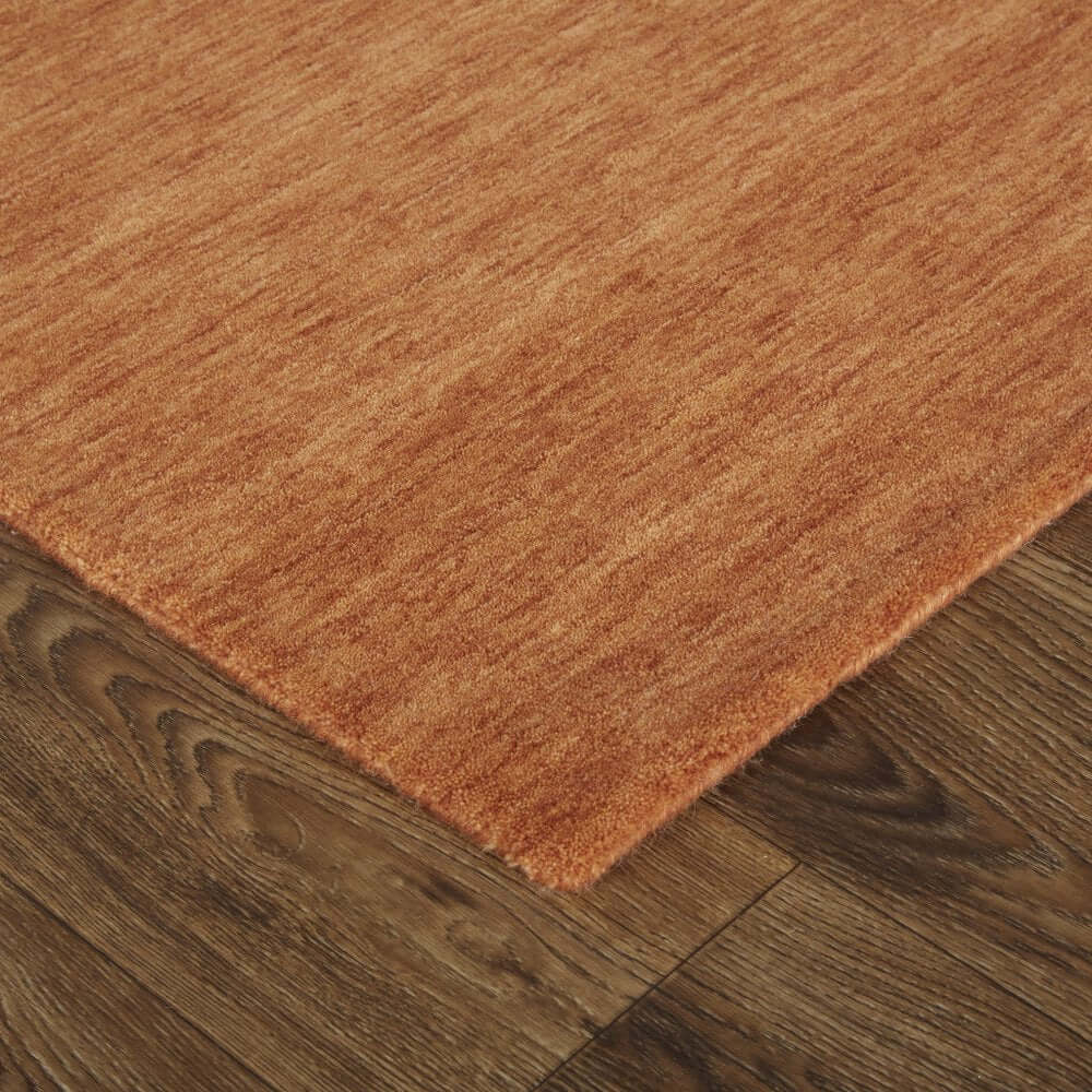 Orange Wool Hand Woven Area Rug | 9' x 13' with rich texture on warm flooring.