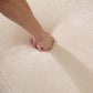 Person pressing hand into soft beige fabric of the Oslo Boucle Sofa – 84” Round Arm Modern 3-Seater Couch (Beige Upholstered).