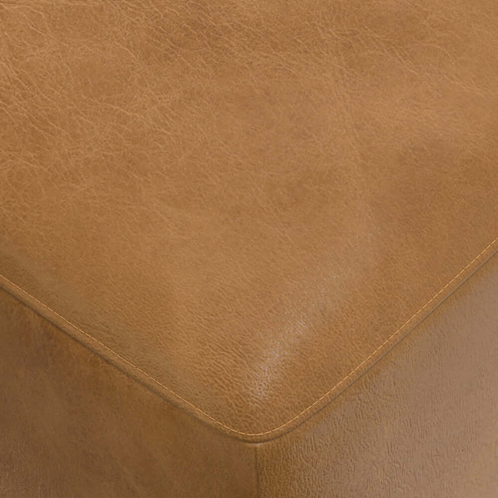 Close-up of the Rex Genuine Leather Square Ottoman in warm tan, highlighting its luxurious texture and craftsmanship.