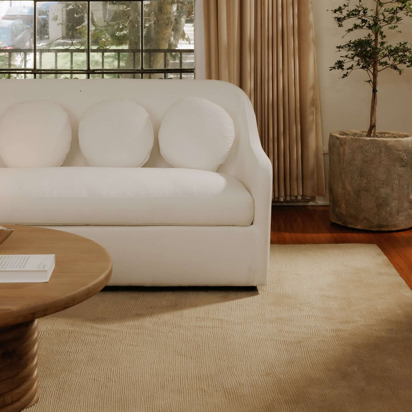 Rialto White Performance Fabric Sofa with Curved Back & Toss Cushions | Modern Sofa in a stylish living room setting.