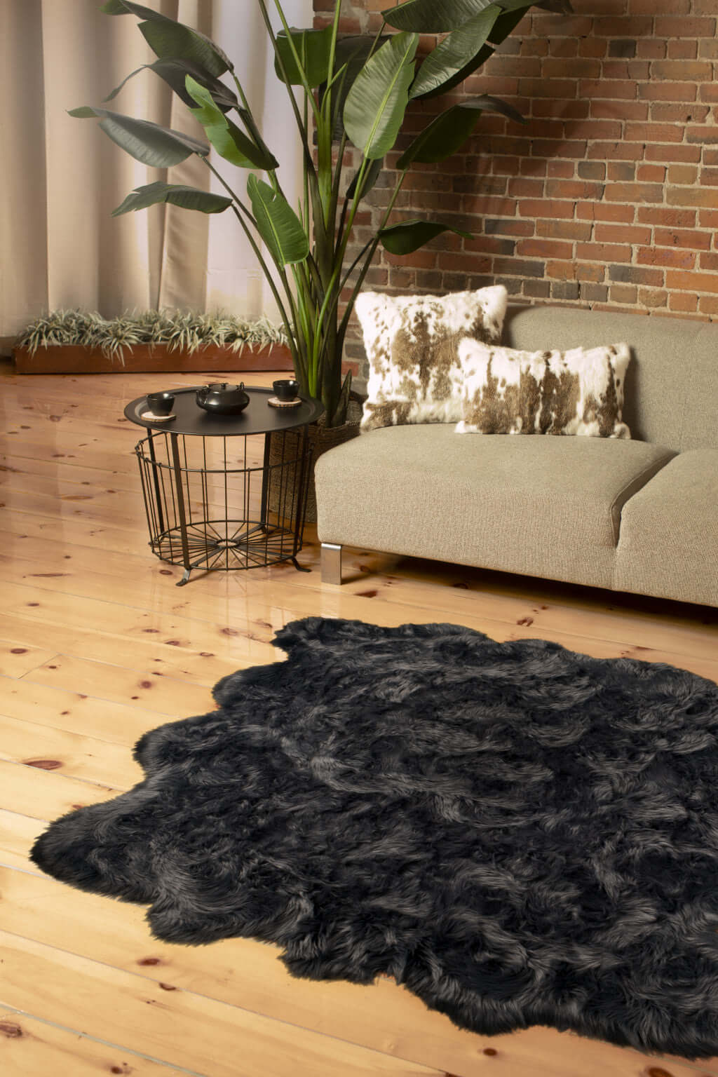 Scalloped faux fur shag rug in a modern living room setting, paired with decorative pillows and plants.