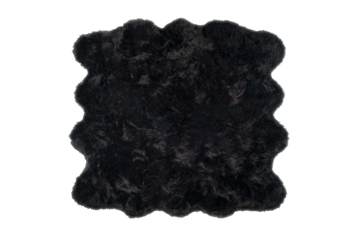 Scalloped faux fur square shag rug in black, 6' x 6', offering softness and style for any modern space.