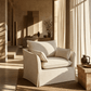 Shane Beige Slipcover Linen Chair w/2 Pillows in a sunlit interior setting.