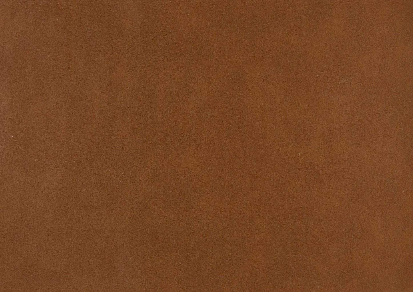 Close-up of faux leather material in warm brown, suitable for upholstery and modern furniture.