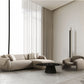 Taupe Boucle L Shaped Two Piece Sofa and Chaise Sectional With Toss Pillows in a stylish living room.