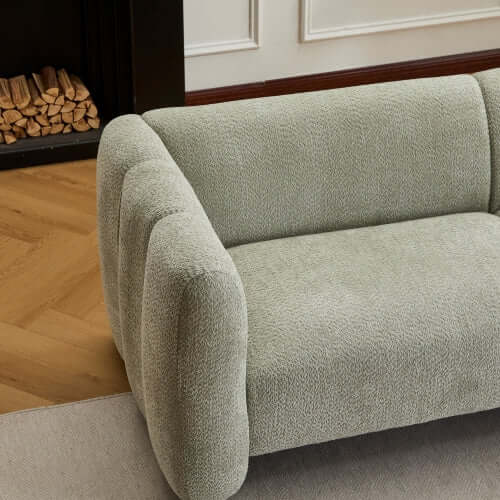 Tonson Boucle Sofa – 83” Curved Wave 3-Seater Sofa (3 Colors, Modern Sculptural Design) in soft green upholstery.