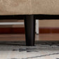 Tonson Boucle Sofa – 83” Curved Wave 3-Seater Sofa (3 Colors, Modern Sculptural Design) leg detail on a patterned rug.