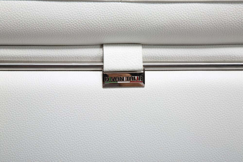 Close-up of the elegant metal detail on the White Italian Leather L Shaped Two Piece Sofa and Chaise Sectional.