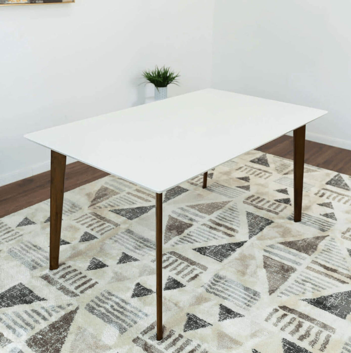 Levi MCM Walnut Dining Table – Rectangular Solid Wood Table (3 Sizes, 2 Colors) on a patterned rug.