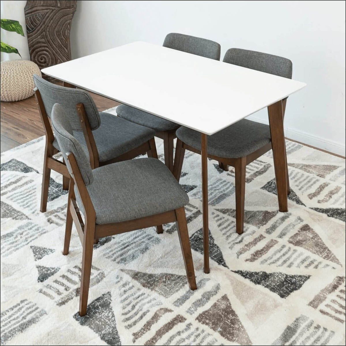 Levi MCM Walnut Dining Table – Rectangular Solid Wood Table (3 Sizes, 2 Colors) with gray chairs on a patterned rug.