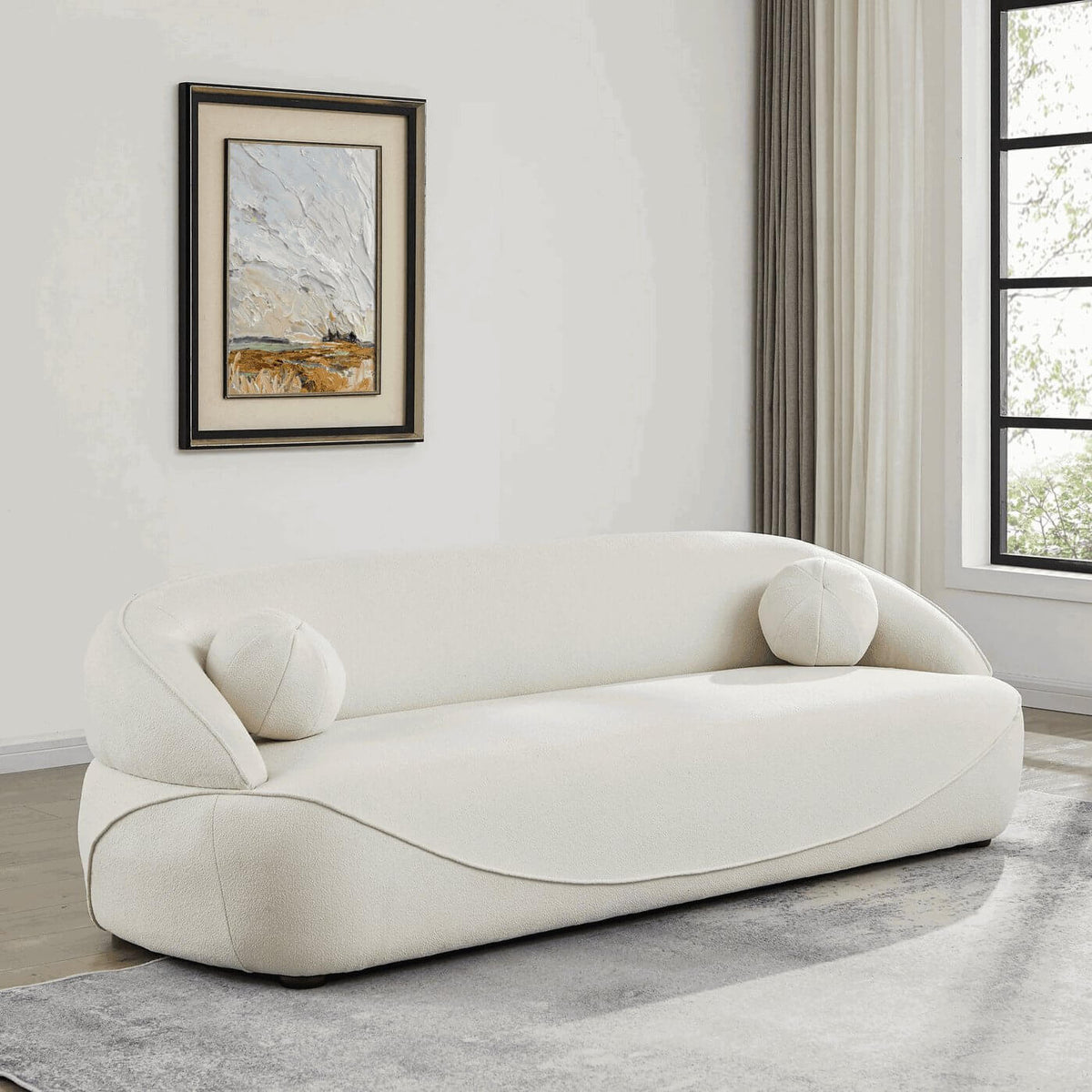 Modern Curved Boucle Sofa 84” (3 Colors) – Andrew Minimalist Sculptural Couch in a stylish living room setting.